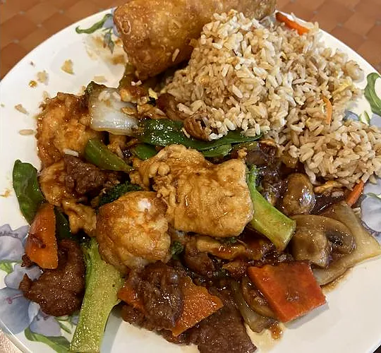 A Golden Leaf dinner plate with fried rice and an egg roll